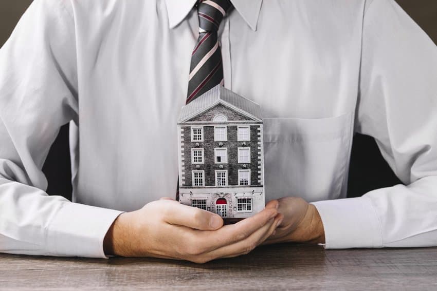 A property owner holding a model house